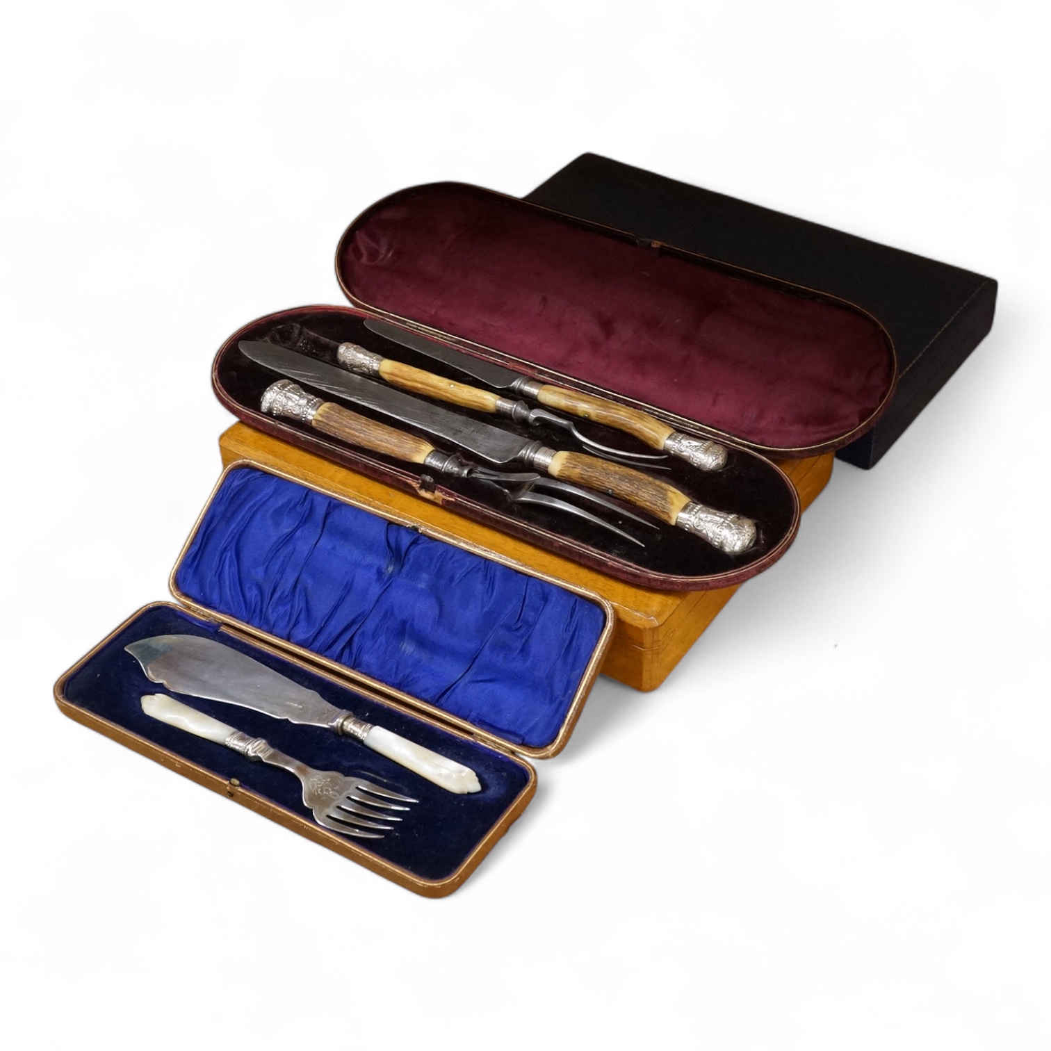 Four cased sets of silver plated flatware, including a carving set with antler handles, silver mounted.